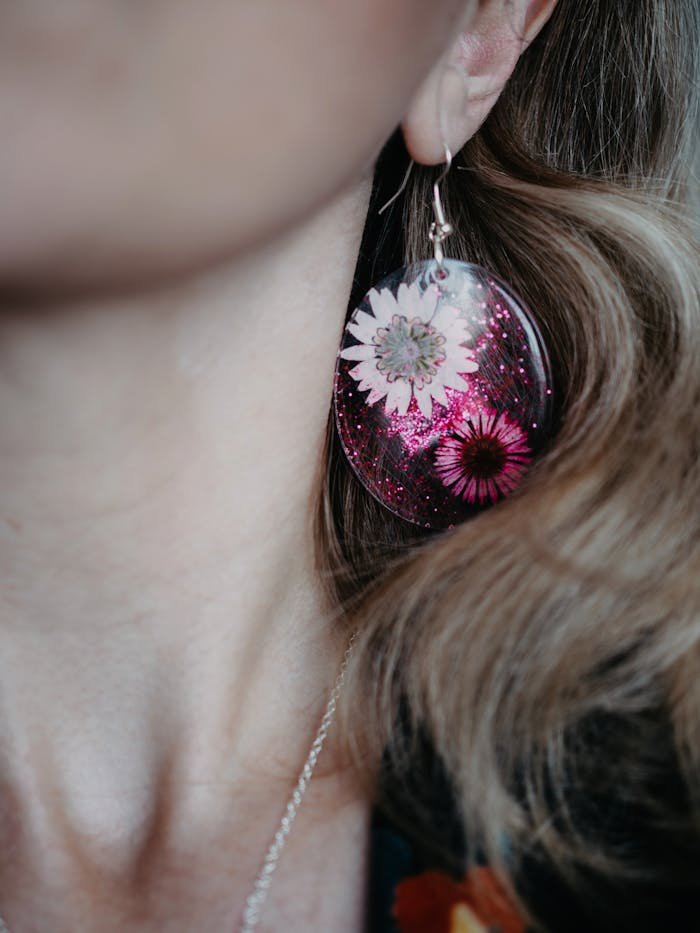 services-02 Elegant close-up of handmade floral resin earring in artistic photography.